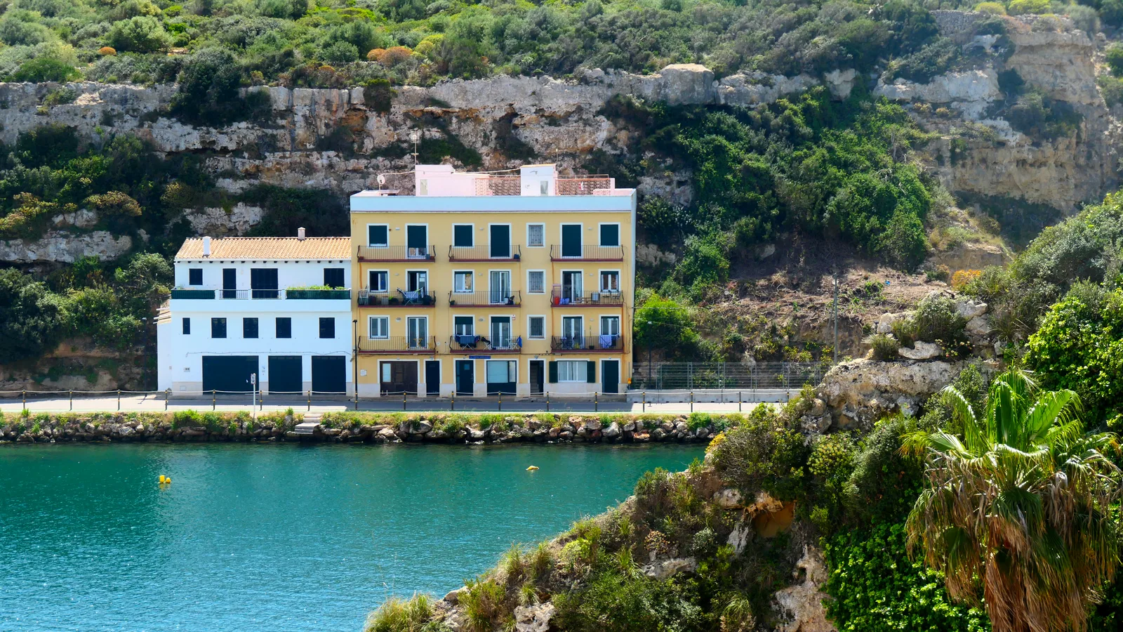 Charming colorful houses by the water in Mahón, Balearic Islands, Spain.